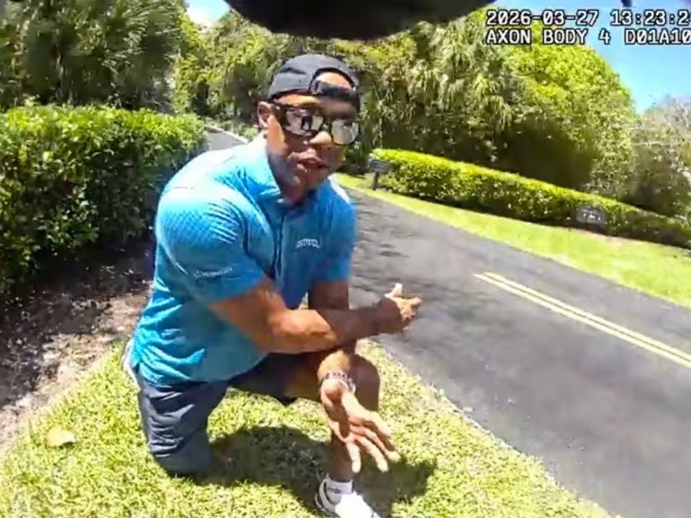 In this image taken from police body camera video released by the Martin County, Fla., Sheriff's Office, golfer Tiger Woods speaks with sheriff's deputies following a car crash in Jupiter Island, Fla.