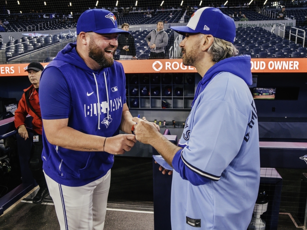 Rogers Game Day Owner Paul Bychko talks with Blue Jays manager John Schneider.