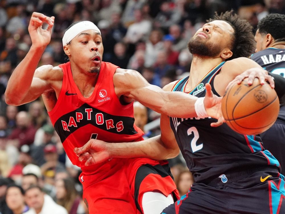 Toronto Raptors forward Scottie Barnes  is called for a foul on Detroit Pistons guard Cade Cunningham.