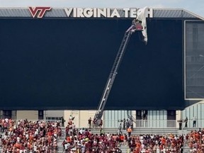 Personnel on a lift work to secure a skydiver that crashed