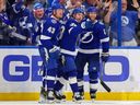 Brandon Hagel (centre) of the Tampa Bay Lightning celebrates his goal against the Montréal Canadiens with Darren Raddysh #43 and Brayden Point.