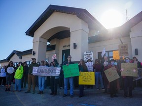 People hold signs during a rally