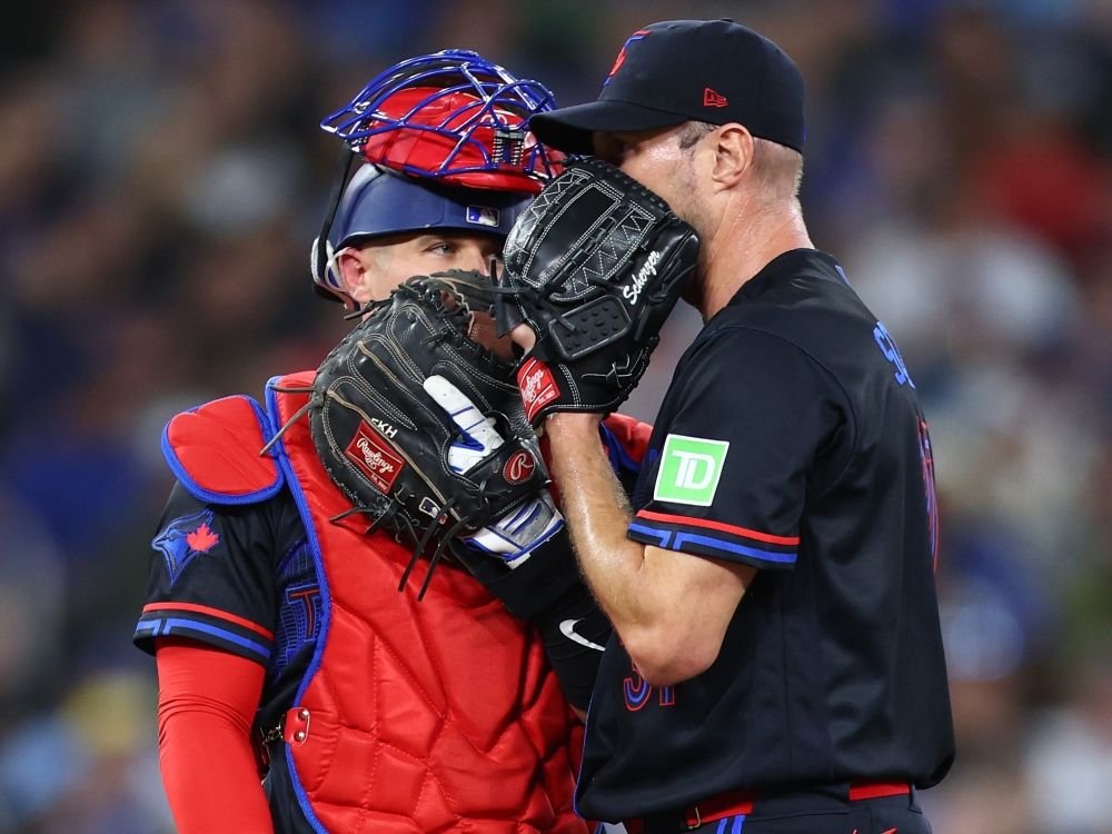 Toronto Blue Jays' Tyler Heineman (left) speaks to Max Scherzer during Friday's game against the Cleveland Guardians.