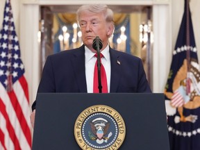 U.S. President Donald Trump pauses as he finishes speaking about the Iran war from the Cross Hall of the White House.