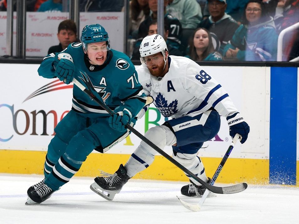 Macklin Celebrini #71 of the San Jose Sharks and William Nylander #88 of the Toronto Maple Leafs go for the puck during the second period at SAP Center on April 02, 2026 in San Jose, California.