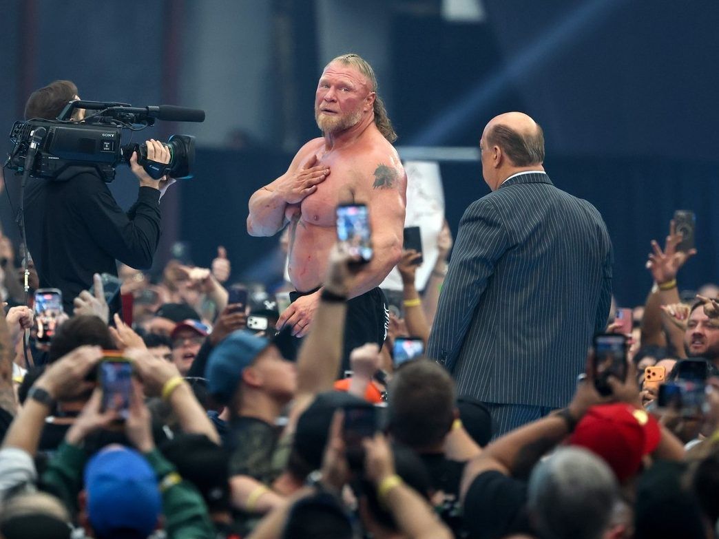 Brock Lesnar (L) looks back and gestures to fans as he and Paul Heyman leave the ring after Lesnar appeared to retire following his loss to Oba Femi in their match during WrestleMania 42 at Allegiant Stadium on April 19, 2026 in Las Vegas, Nevada.