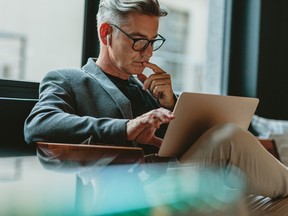 Older man looking at laptop.