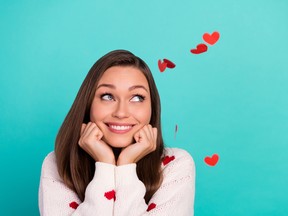 Photo of pretty minded person hands touch cheeks look empty space isolated on teal color background
