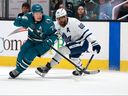Macklin Celebrini #71 of the San Jose Sharks and William Nylander #88 of the Toronto Maple Leafs go for the puck during the second period at SAP Center on Thursday.