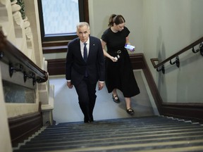 Prime Minister Mark Carney walks to his office for a cabinet meeting on Parliament Hill in Ottawa on April 28, 2026.