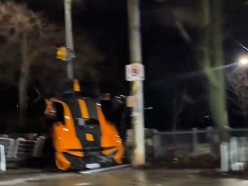 Screenshot of orange McLaren that crashed into a bike rack near Casa Loma.
