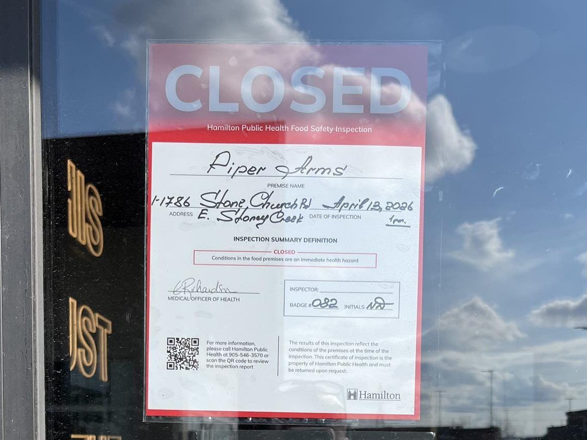 Red closed notice from Hamilton Public Health on door of Piper Arms in Stoney Creek.