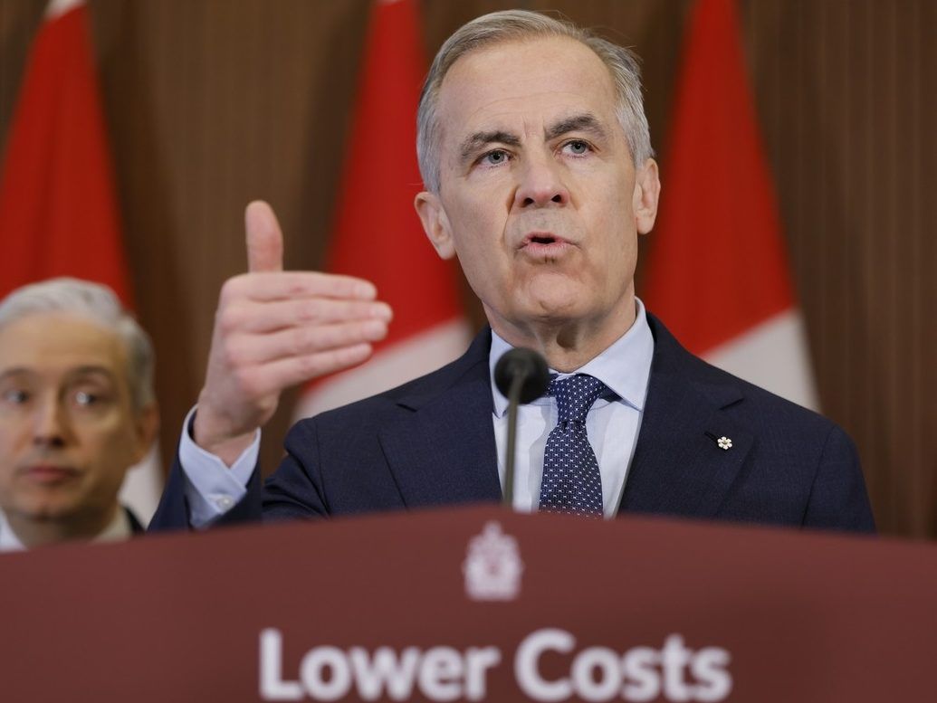 Prime Minister Mark Carney, with Minister of Finance Francois-Philippe Champagne, takes part in a press conference on Parliament Hill in Ottawa April 14, 2026.  