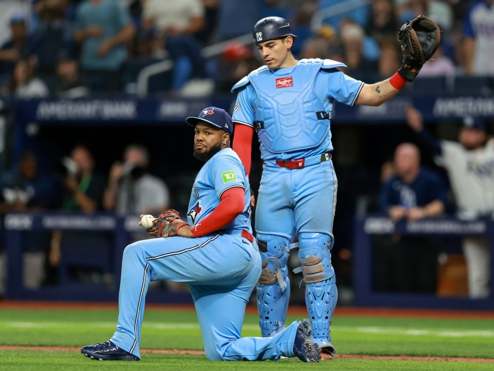 Vladimir Guerrero Jr. (left) and Brandon Valenzuela of the Toronto Blue Jays react after the Tampa Bay Rays score a run.