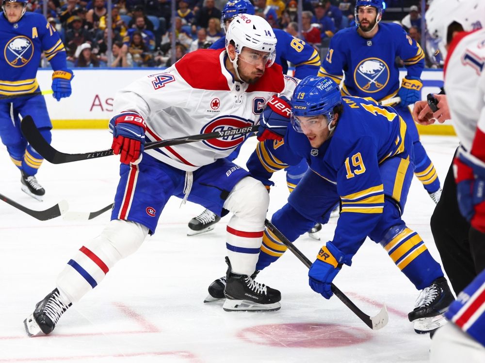 Montreal Canadiens centre Nick Suzuki and Buffalo Sabres' Peyton Krebs battle after a face-off during Game 1 of their playoff series.