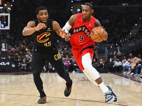 RJ Barrett of the Toronto Raptors drives to the basket against Donovan Mitchell of the Cleveland Cavaliers.