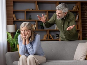 Senior man yelling at frustrated mature woman.