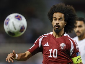 Qatar's Akram Afif eyes the ball during a 2026 FIFA World Cup Asian Qualifier football match against Iran.
