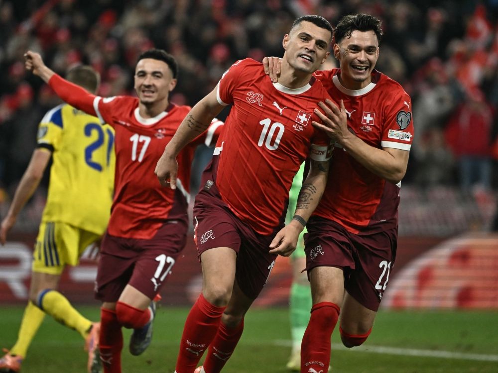 Switzerland's Granit Xhaka (centre) celebrates after scoring a penalty during the FIFA World Cup 2026 qualifier against Sweden.