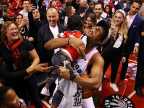 Kyle Lowry celebrates with his sons Kameron and Karter after defeating the Milwaukee Bucks 100-94 in Game 6 of the NBA Eastern Conference Finals at Scotiabank Arena on May 25, 2019.