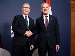 British Prime Minister Keir Starmer shakes hands with Canadian Prime Minister Mark Carney.