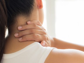 Closeup woman neck and shoulder pain and injury. Health care and medical concept.