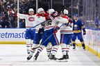 Alex Newhook #15 of the Montréal Canadiens celebrates with teammates after scoring a goal against the Buffalo Sabres during overtime in Game Seven of the Second Round of the 2026 Stanley Cup Playoffs at KeyBank Center in Buffalo on Tuesday.