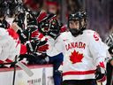 OTTAWA, CANADA - Gavin McKenna #9 of Team Canada celebrates his goal with teammates on the bench during the first period at the 2025 IIHF World Junior Championship against Team Finland at Canadian Tire Centre December 26, 2024 in Ottawa, Ontario, Canada.