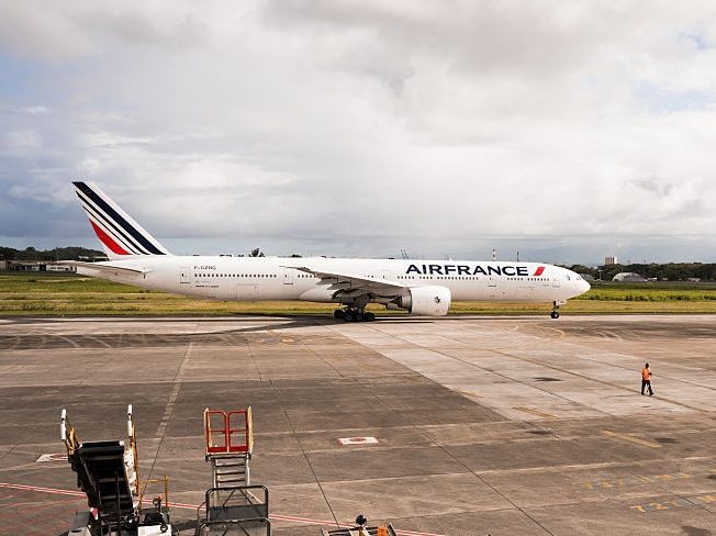 This photograph taken in Les Abymes, on the French Caribbean island of Guadeloupe on May 4, 2026, shows the Boeing 777 F-GZNG of French airline Air France about to take off from the tarmac at Maryse Conde airport's international terminal.