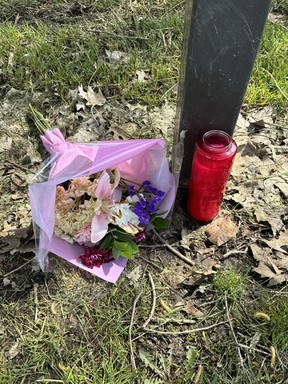 Flowers and a candle were set up at Wenderly Park in North York where an unnamed person was shot dead last Thursday. JOE WARMINGTON/TORONTO SUN