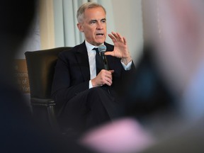 Mark Carney gestures while speaking