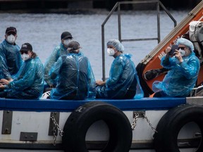 Passengers are evacuated by small boat from the MV Hondius in the Granadilla Port on May 10, 2026 in Tenerife, part of the Canary Islands, Spain.