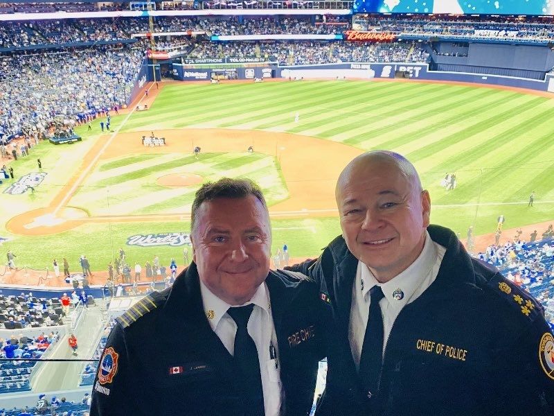 While city officials have yet to provide specifics about the duties and days worked by TFS Chief Jim Jessop, left, and TPS Chief Myron Demkiw at the Rogers Centre during recent big-ticket events, social media photos show them together during Game 1 of the World Series.