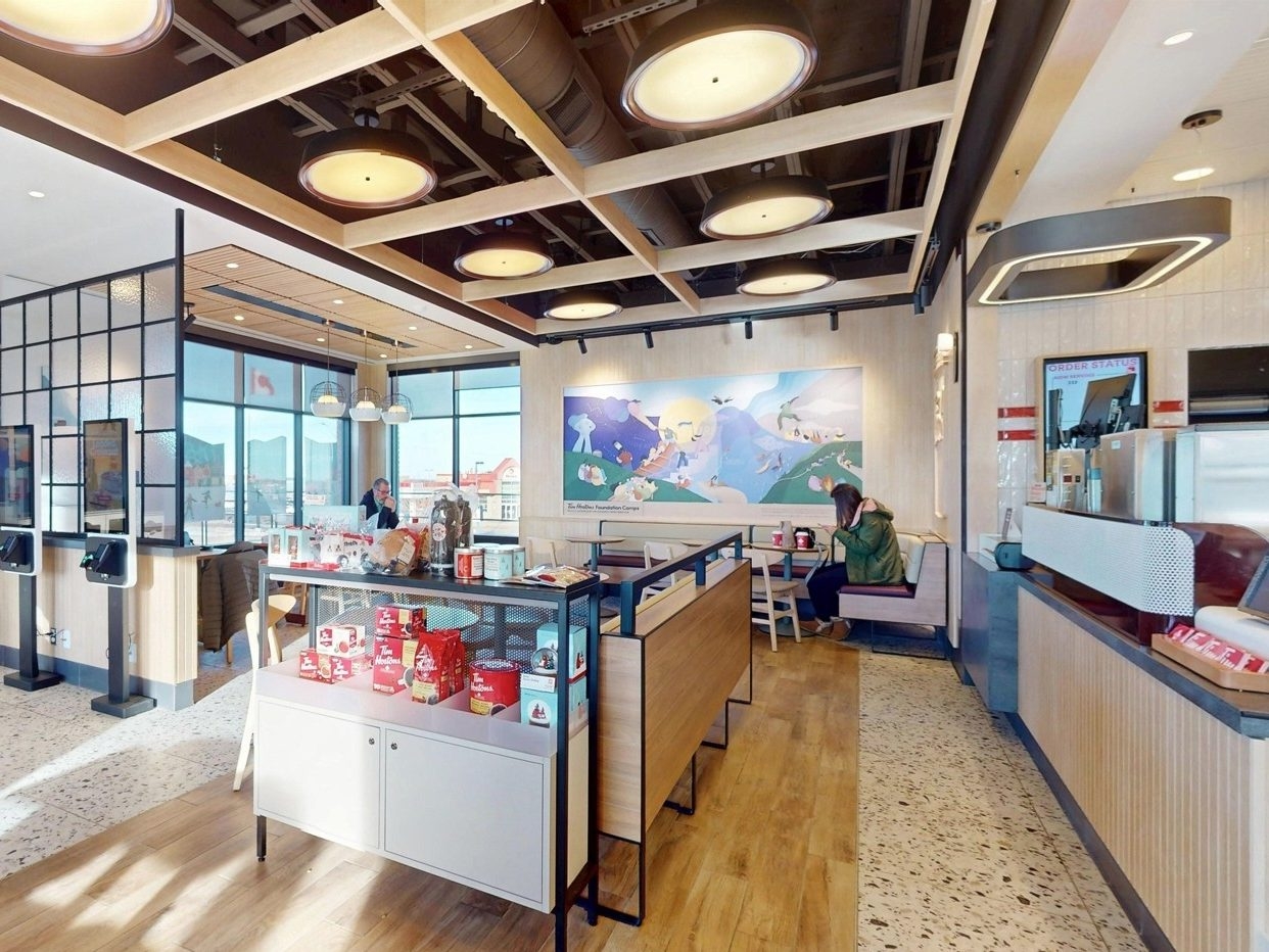  Inside a brighter, more modern Tim Hortons restaurant.