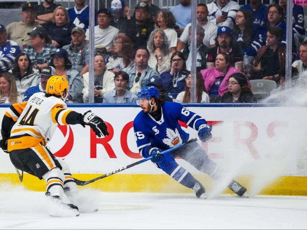 Reese Johnson of the Toronto Marlies produces a spray of ice shavings while dealing with Chase Pietila of the Wilkes-Barre/Scranton Penguins during an AHL playoff game at Coca-Cola Coliseum in Toronto on June 3, 2026.
