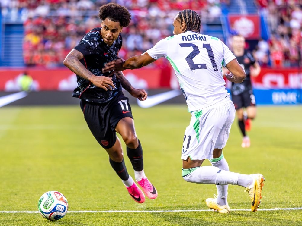 Canada midfielder Tajon Buchanan attempts to dribble past Republic of Ireland defender Corrie Ndaba during the first half of a FIFA international friendly.