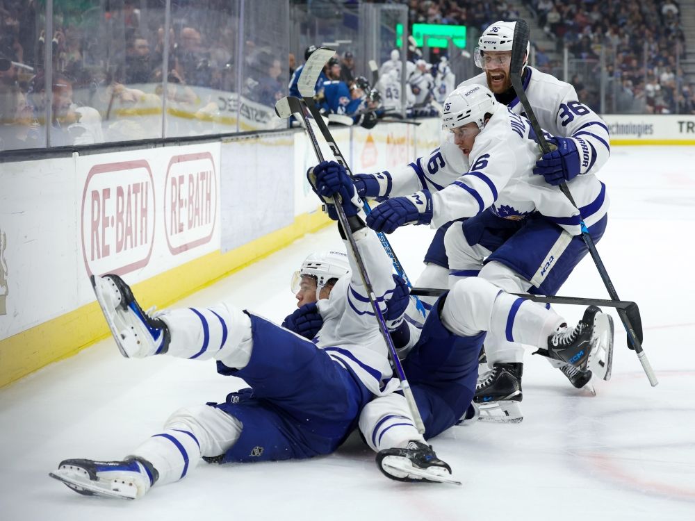 Toronto Marlies’ Easton Cowan (53) is mobbed by teammates after scoring the game-winning goal against the Cleveland Monsters last month.