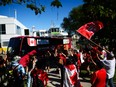 Fans cheer as Team Canada's bus drives by after arriving at Billy Bishop Toronto City Airport for the FIFA World Cup 2026.