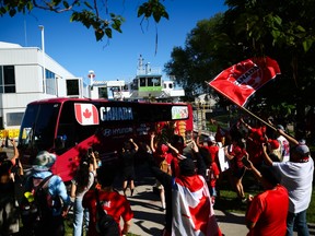 Fans cheer as Team Canada's bus drives by after arriving at Billy Bishop Toronto City Airport for the FIFA World Cup 2026.