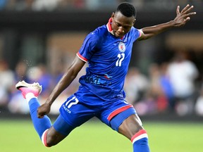 Haiti midfielder Danley Jean Jacques takes a shot on goal during an international friendly football match against Peru.