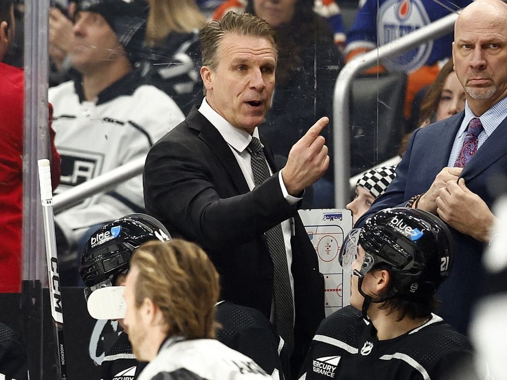 Former interim head coach Jim Hiller of the Los Angeles Kings signals his team during play against the Edmonton Oilers in 2024. 
