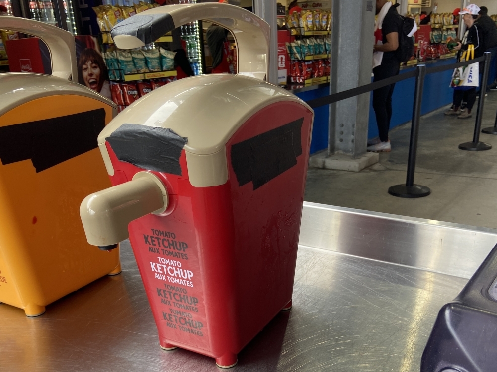 Ketchup and mustard dispensers at Toronto Stadium have their logos covered during the FIFA World Cup.