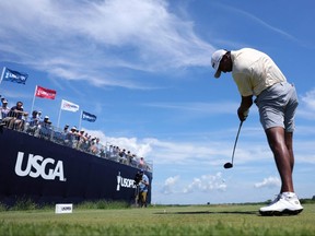 Sudarshan Yellamaraju of Canada tees off on the 12th hole
