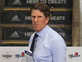Former Toronto Maple Leafs head coach Mike Babcock takes in the warm-up prior to a game against the Boston Bruins in 2019.