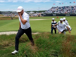 Wyndham Clark (left) walks off the 18th green after his second round at the U.S. Open.