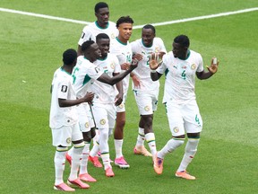 Habib Diarra #21 of Senegal celebrates with teammates after scoring his team's first goal against Iraq during the FIFA World Cup 2026.