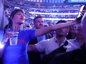 Taylor Swift takes a selfie with a fan during halftime of Game 4 of the 2026 NBA Finals between the San Antonio Spurs and the New York Knicks.