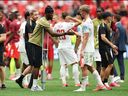 Injured Ismael Kone of Canada greets his teammate Luc de Fougerolles after the team's 2-1 loss to Switzerland at BC Place on June 24, 2026.