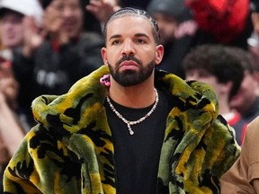 Drake watches on as the Sacramento Kings play the Toronto Raptors during the second half of their basketball game at the Scotiabank Arena on November 2, 2024 in Toronto, Ontario, Canada.