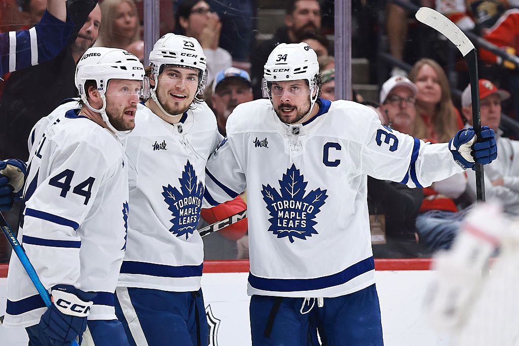  Auston Matthews #34 of the Toronto Maple Leafs, right, celebrates a goal against the Florida Panthers with teammates Morgan Rielly #44 and Matthew Knies #23 of the Toronto Maple Leafs during the third period in Game Six of the Second Round of the 2025 Stanley Cup Playoffs at Amerant Bank Arena on May 16, 2025 in Sunrise, Florida. 